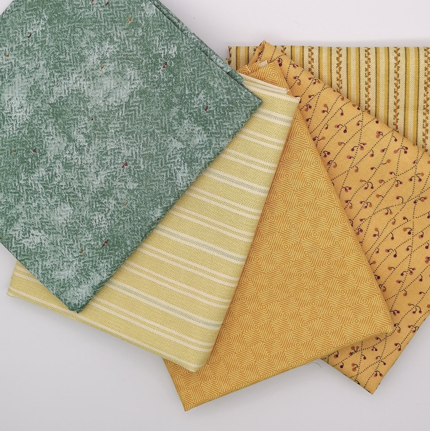 Fat Quarter Bundle LBQ20 - fanned arrangement showing all 5 fat quarters including sage tonal, yellow stripe, mustard gold geometric, burgundy floral vine and cream stripe