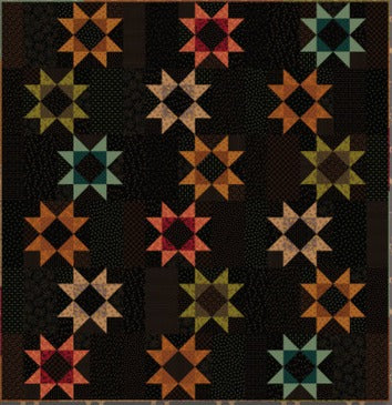 A square quilt pattern or fabric design featuring a repeating starburst motif in orange, red, teal, olive green, and tan on a very dark brown or black background.