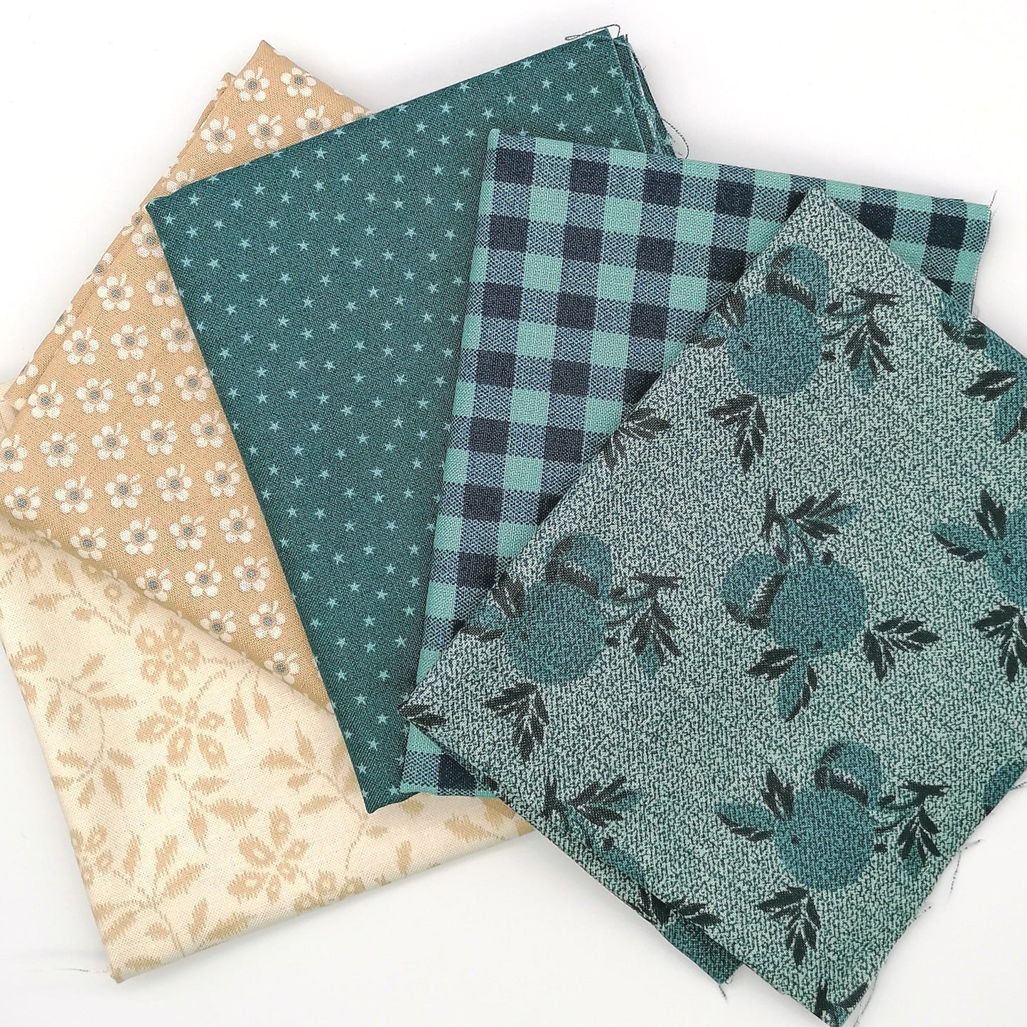 Fat Quarter Bundle LBQ19 - fanned flat lay showing teal botanical tonal, gingham plaid, star dot, sand floral and cream vine fat quarters from Laundry Basket Quilts for Andover Fabrics