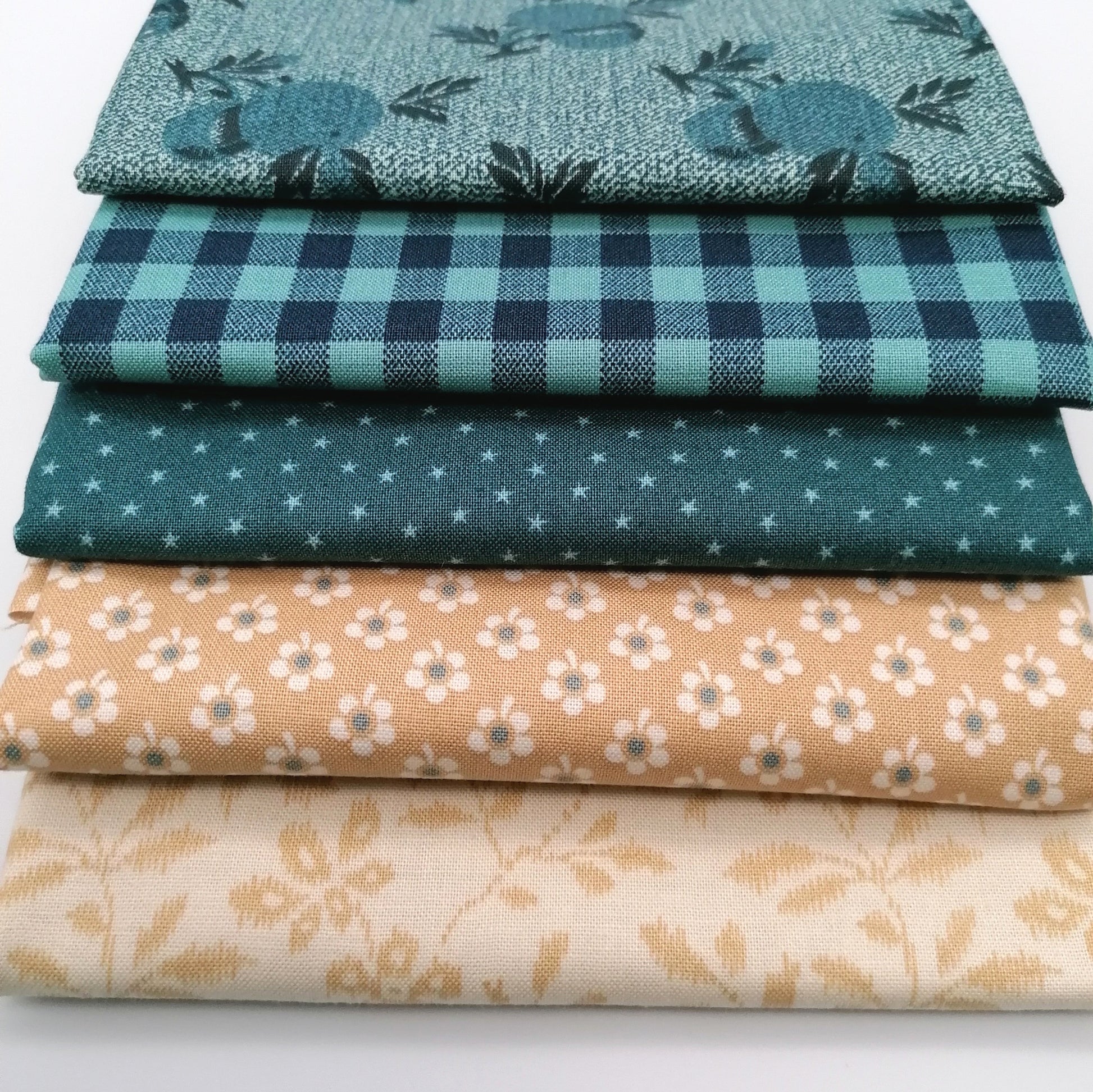 Fat Quarter Bundle LBQ19 - fanned arrangement showing teal star dot, gingham, botanical tonal, sand ditsy floral and cream vine fat quarters from Laundry Basket Quilts