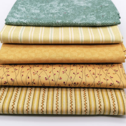 Fat Quarter Bundle LBQ20 - 5 fat quarters stacked showing sage mottled tonal, soft yellow cream stripe, mustard gold diamond geometric, golden sand burgundy floral vine, and cream gold multi-stripe from Laundry Basket Quilts