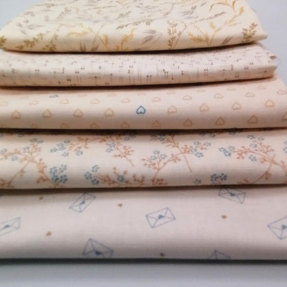 Fat Quarter Bundle LBQ21 - stacked fat quarters showing cream botanical, blush grid, blush hearts, orange branch floral and cream envelope prints from Laundry Basket Quilts for Andover Fabrics
