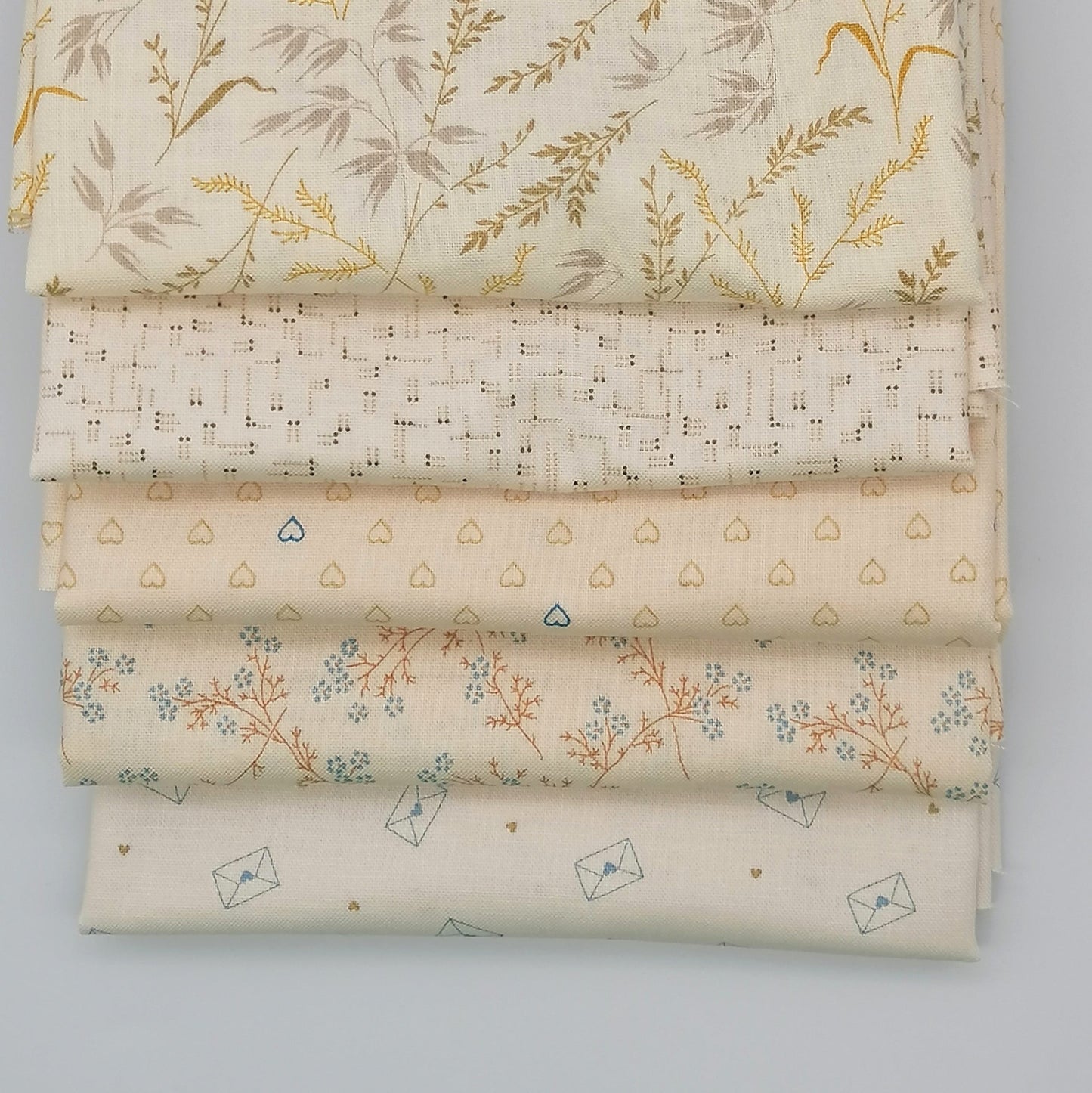 Fat Quarter Bundle LBQ21 - close up detail of cream botanical grasses, blush cross-stitch grid, and heart print fat quarters