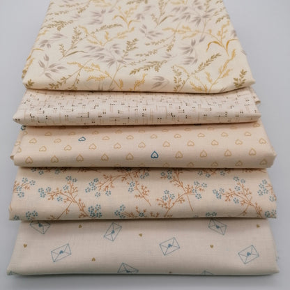 Fat Quarter Bundle LBQ21 - close up stack showing blush hearts, orange branch with blue ditsy flowers, and cream letter envelope fat quarters from Laundry Basket Quilts
