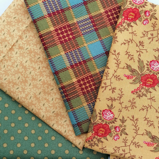 Fat Quarter Bundle LBQ24 - 4 fat quarters fanned showing golden yellow red rose floral vine, mustard teal tartan plaid, warm sand leaf tonal, and sage green gold polka dot from Laundry Basket Quilts