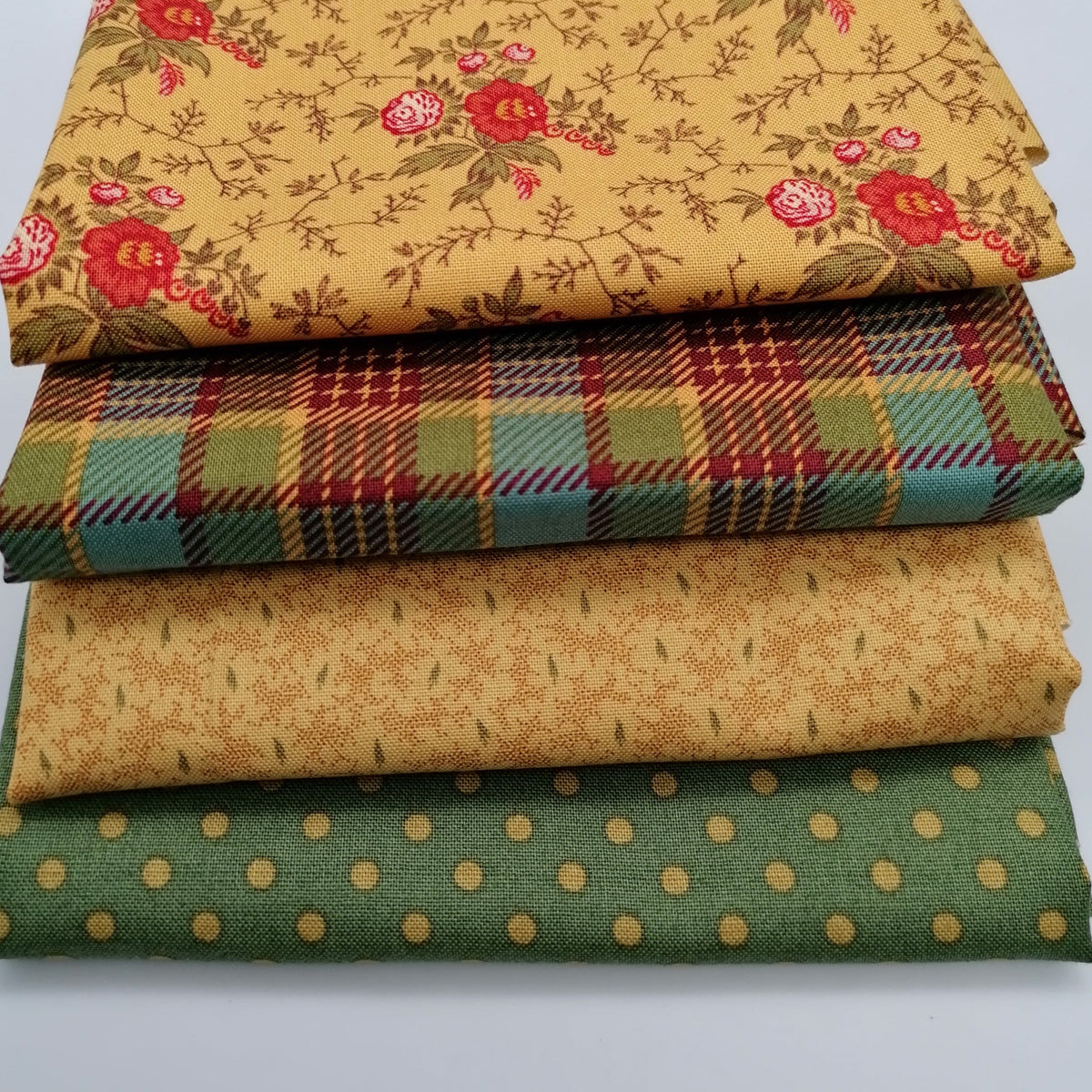 Fat Quarter Bundle LBQ24 - close up stack showing all 4 fat quarters including golden rose floral, teal tartan plaid, warm sand tonal and sage green dot prints