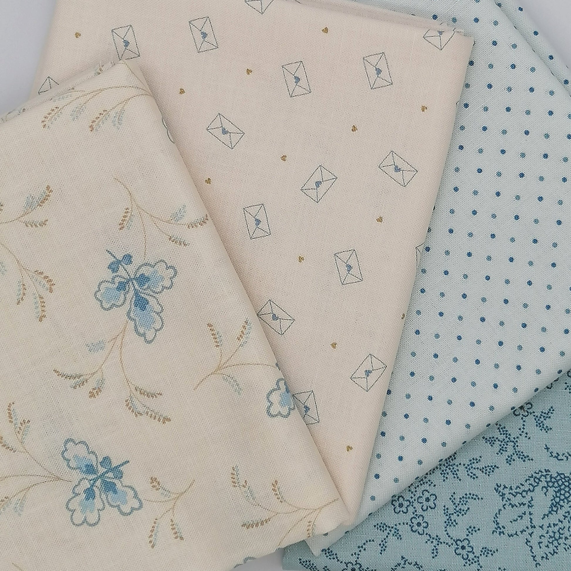 LBQ22 fat quarter bundle featuring Special Delivery and Blue Escape fabrics in cream and light blue