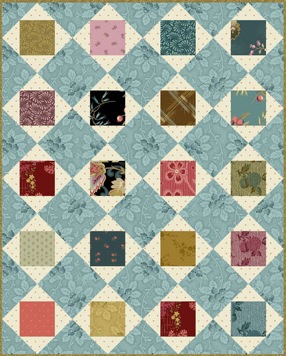 Quilt with a diamond pattern featuring various small fabric squares in different colors and patterns.