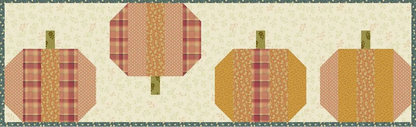 A quilted fabric wall hanging or banner featuring four stylized pumpkins arranged horizontally on a cream floral background with a green patterned border.