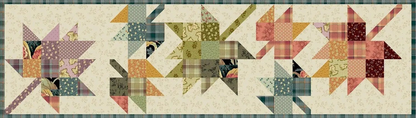 A quilted fabric banner featuring five stylized starburst or pinwheel motifs in various floral and plaid patterns, set against a cream background with a green plaid border.