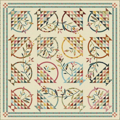 Colorful quilt with geometric and floral patterns on a beige background