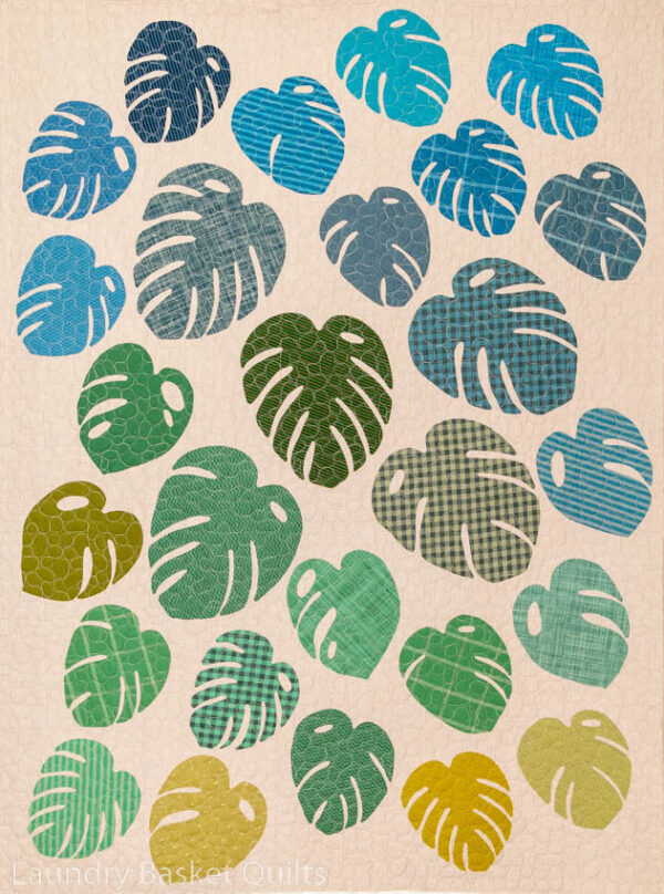 Monstera Quilt Pattern by Laundry Basket Quilts, finished size 43½" x 58½", featuring appliqué monstera leaves, perfect for raw-edge, hand, or backstitch techniques.