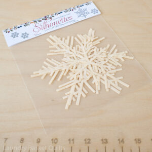 A package of 6 laser-cut snowflake fabric silhouettes in white, featuring 3 large and 3 small snowflakes, pre-fused and ready for quilting. Perfect for winter-themed projects like the Sleigh Trio Pattern