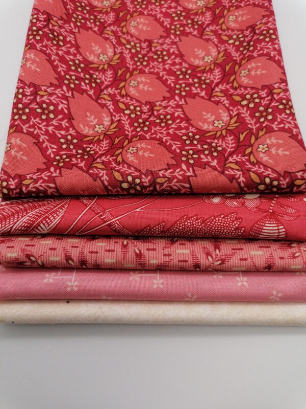 a selection of red and pink fabrics for heart quilts